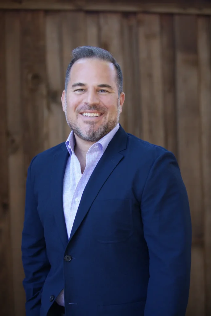 Professional headshot of Dr. Racanelli: lead cosmetic dentist and expert in high-quality smile design and dental veneers.